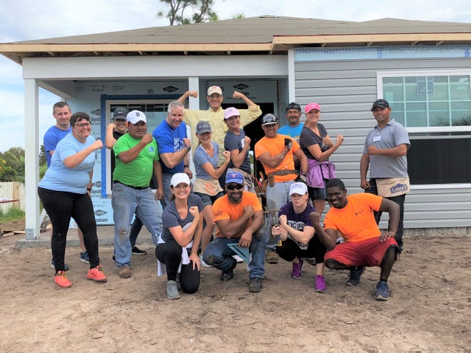 Volunteers with Habitat for Humanity pose for a picture.